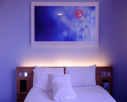 Soft white bedding and pillows in a calm bedroom environment